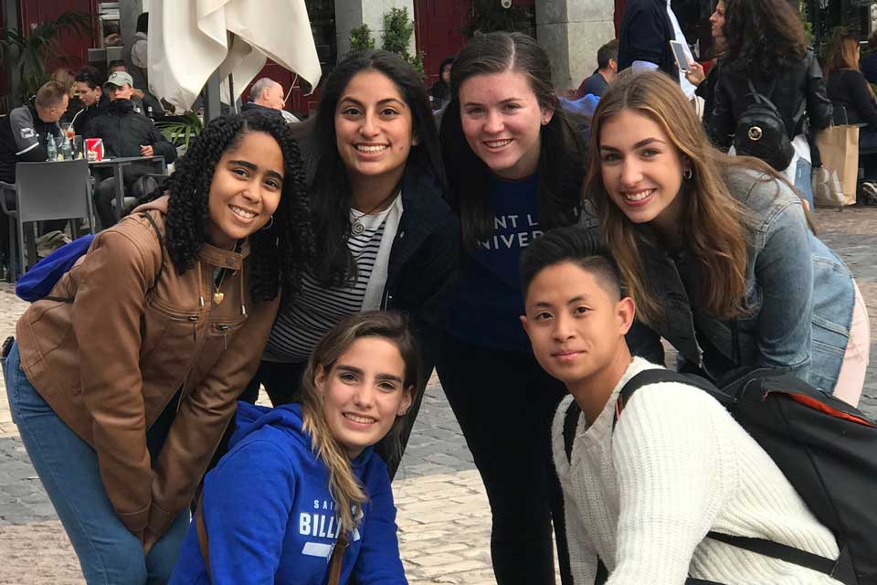 A group of SLU students outside in a city plaza in Madrid 