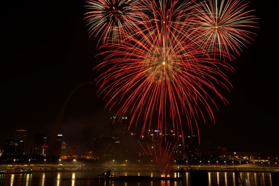 Fireworks explode over the Mississippi River at night in down St. ֱοƵ. The skyline is in the background.