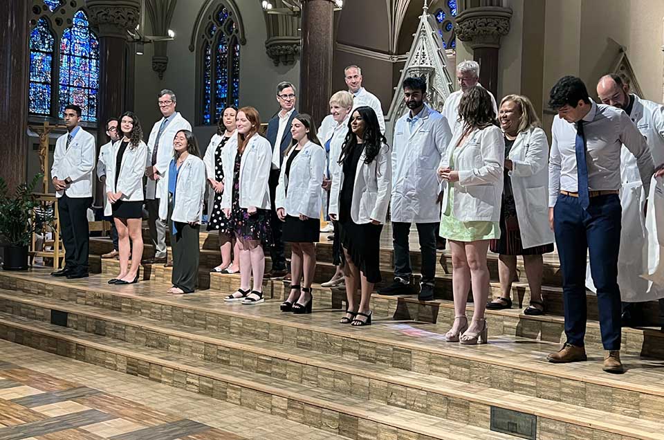 A group of new Saint ֱοƵ University School of Medicine students receive their white coats. 